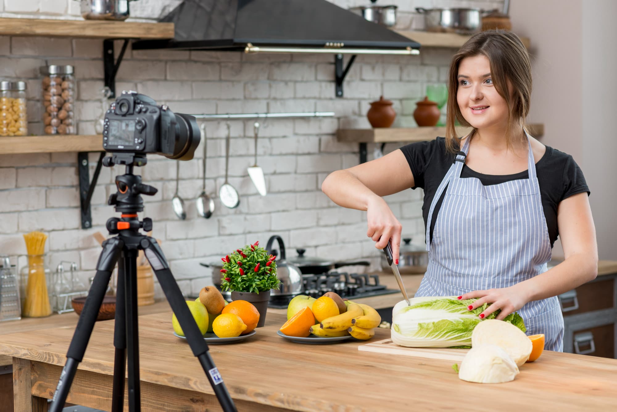 food creator filming a recipe in her kitchen.