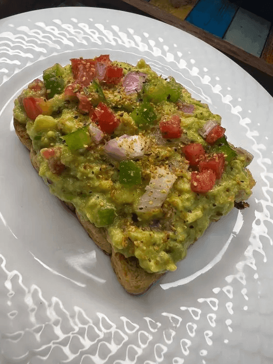 An avocado toast placed on a plate