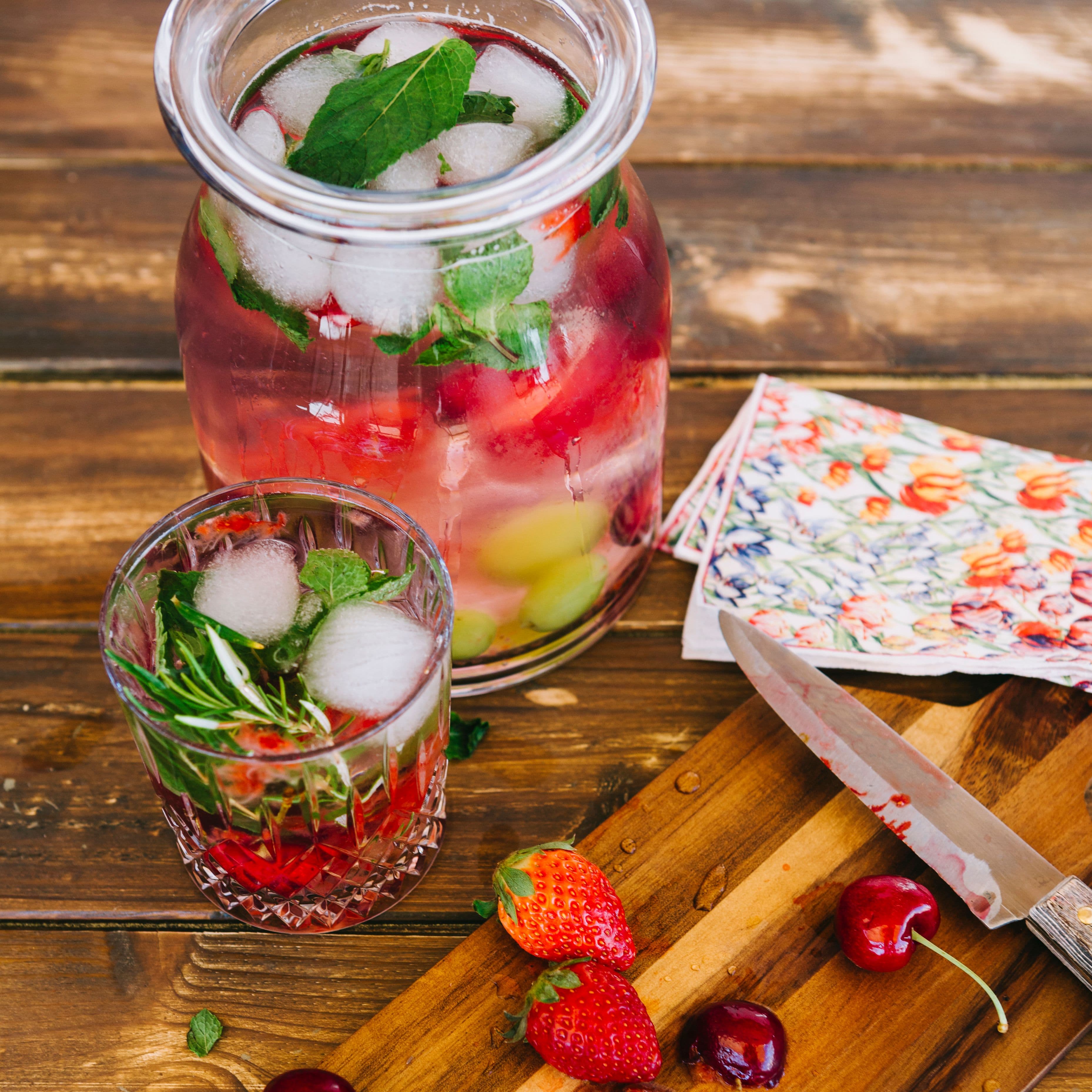 close-up-healthy-juice-with-berries-basil-ice-cubes-jar