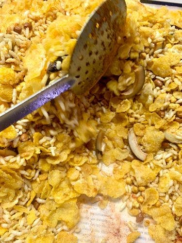 Cornflakes-Mixture-(Namkeen)-Tossing-Mixture-With-Slotted-Spoon.jpg
