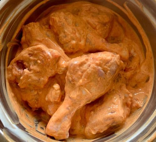 Raw chicken pieces marinated in spiced yogurt mix