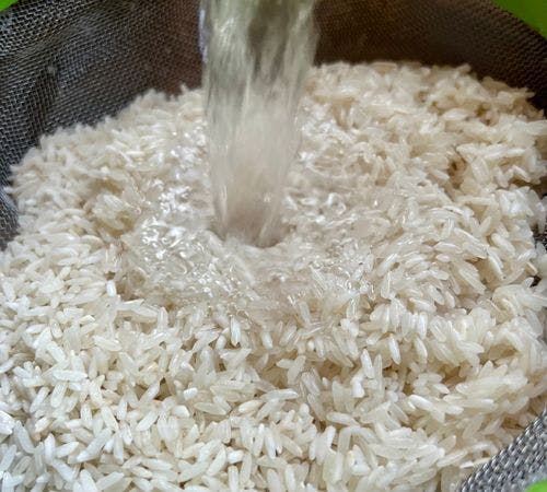 Step 1.1: First, rinse the rice thoroughly by placing in a sieve and rinsing with cold water