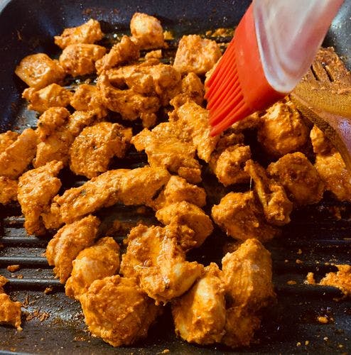Peri-Peri-Chicken-Skillet-Brushing-Oil-On-Marinated-Chicken-in-Skillet.jpg