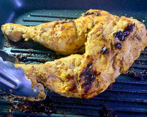 Peri-Grilled-Chicken-Charred-And Slightly-Golden-Chicken-Whole-Legs-On-Grill-Pan.jpg