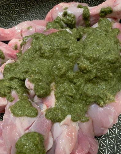 Raw chicken drumsticks with mint paste on top