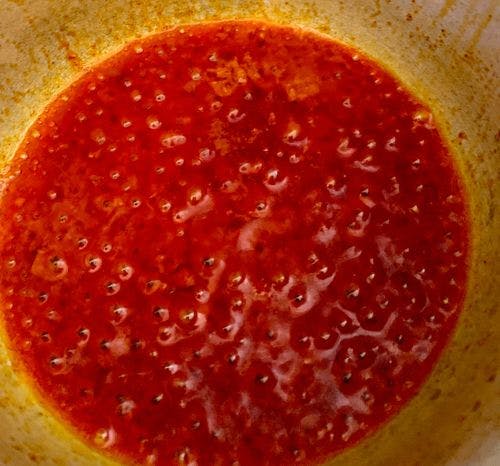 Bubbling oil marinade, red in colour.