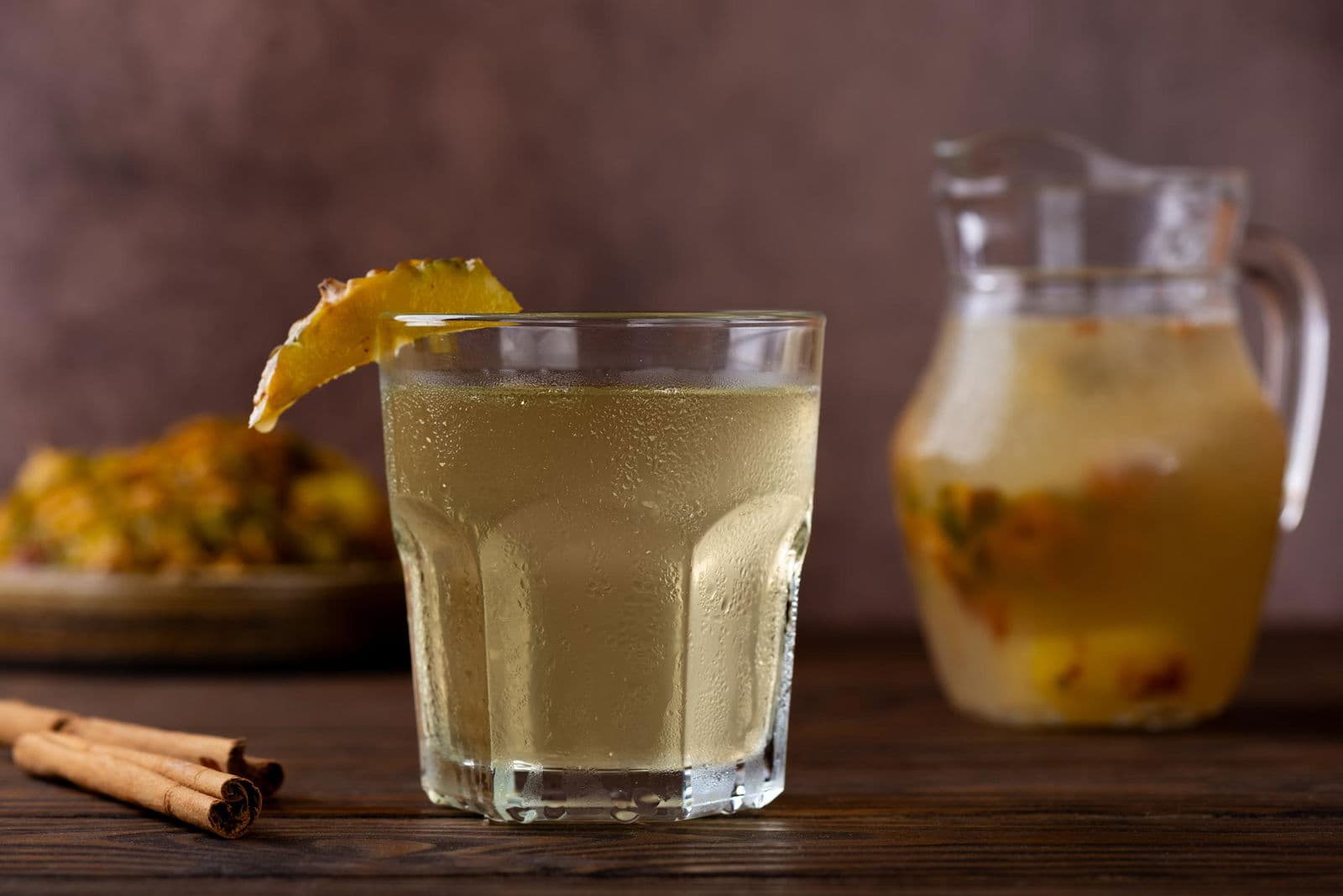 Pineapple drink kvass tepache in a glass on a wooden table fermented probiotic drink