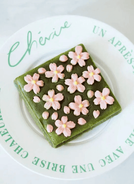 A piece of Sakura of Spring Matcha White Chocolate Sakura Brownie served on a plate.