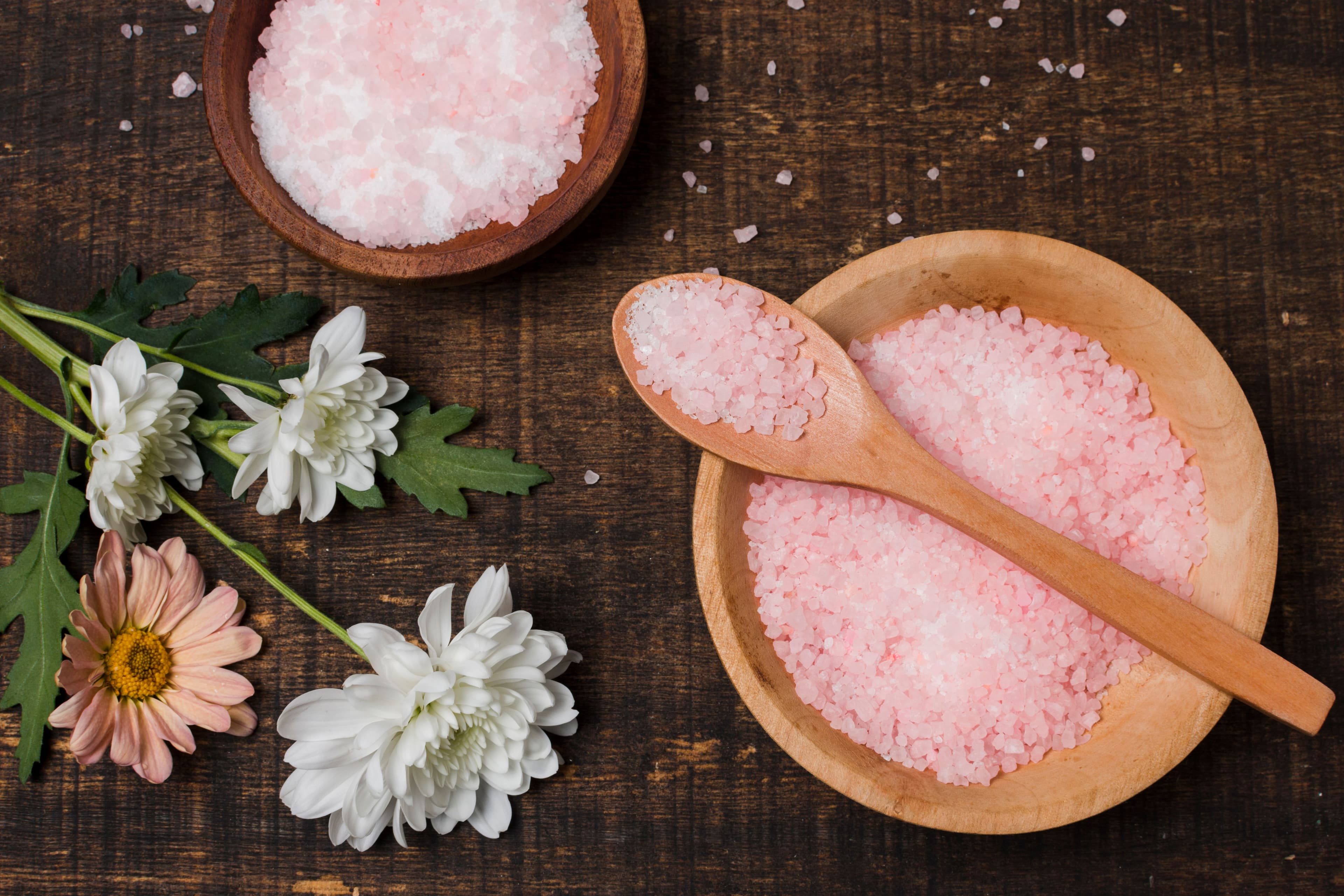 Himalayan salt placed in two bowls and scooped in a wooden spoon