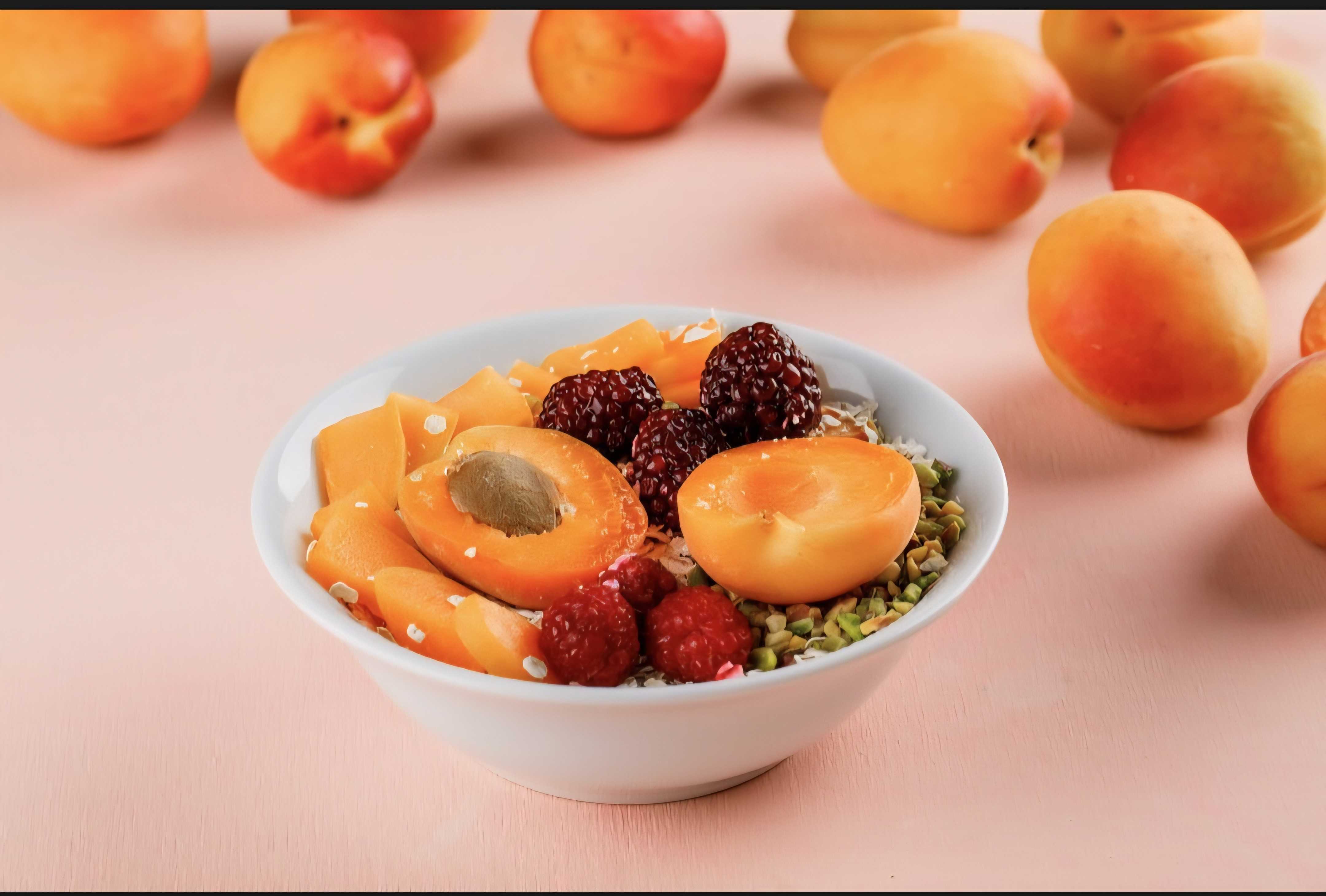 A bowl of peaches and berries
