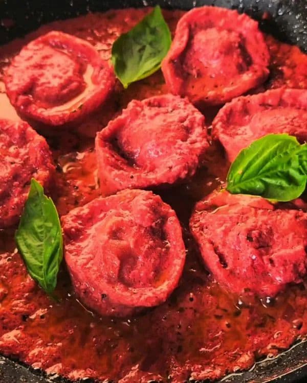A close-up of freshly cooked Beet-Dyed Homemade Pasta with Creamy Beet Sauce.