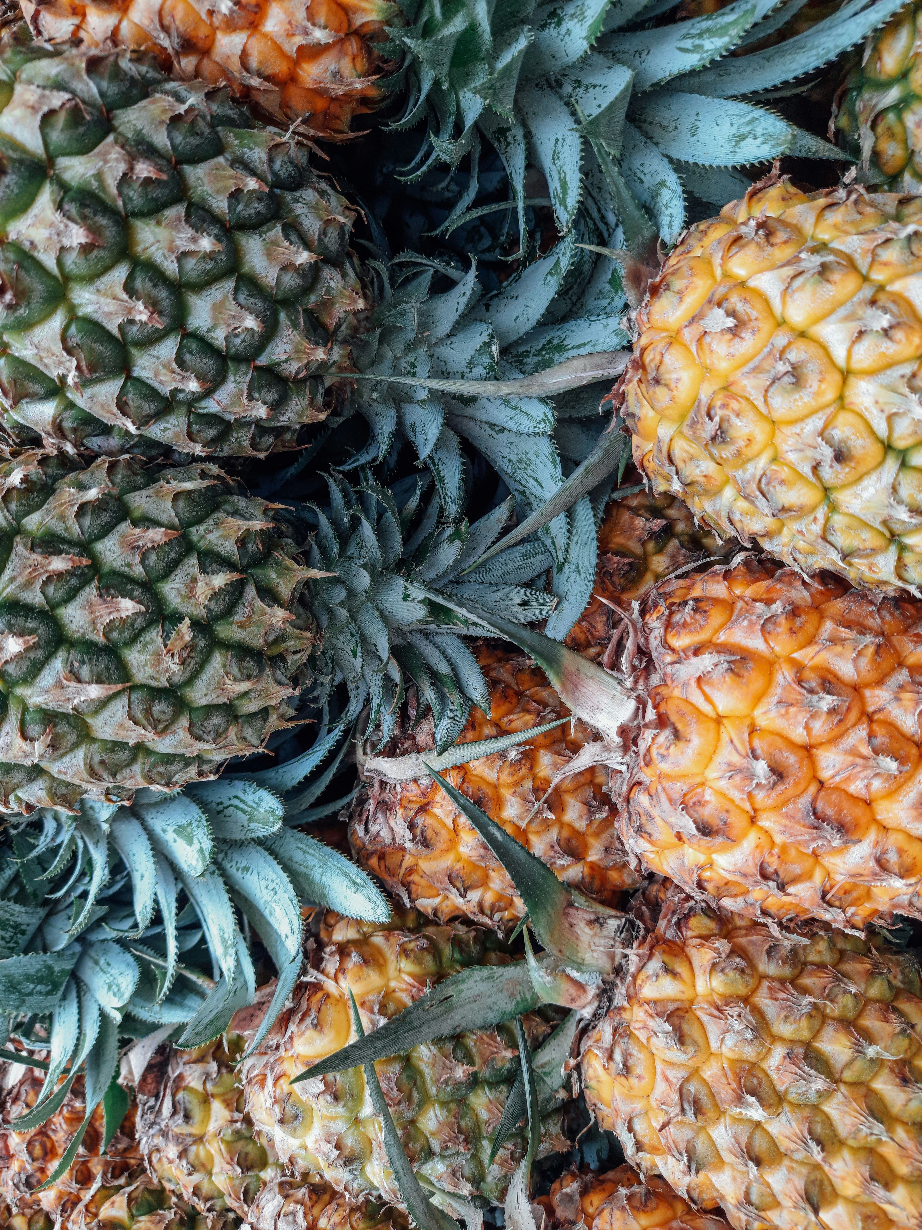 Several pineapples piled on top of each other.