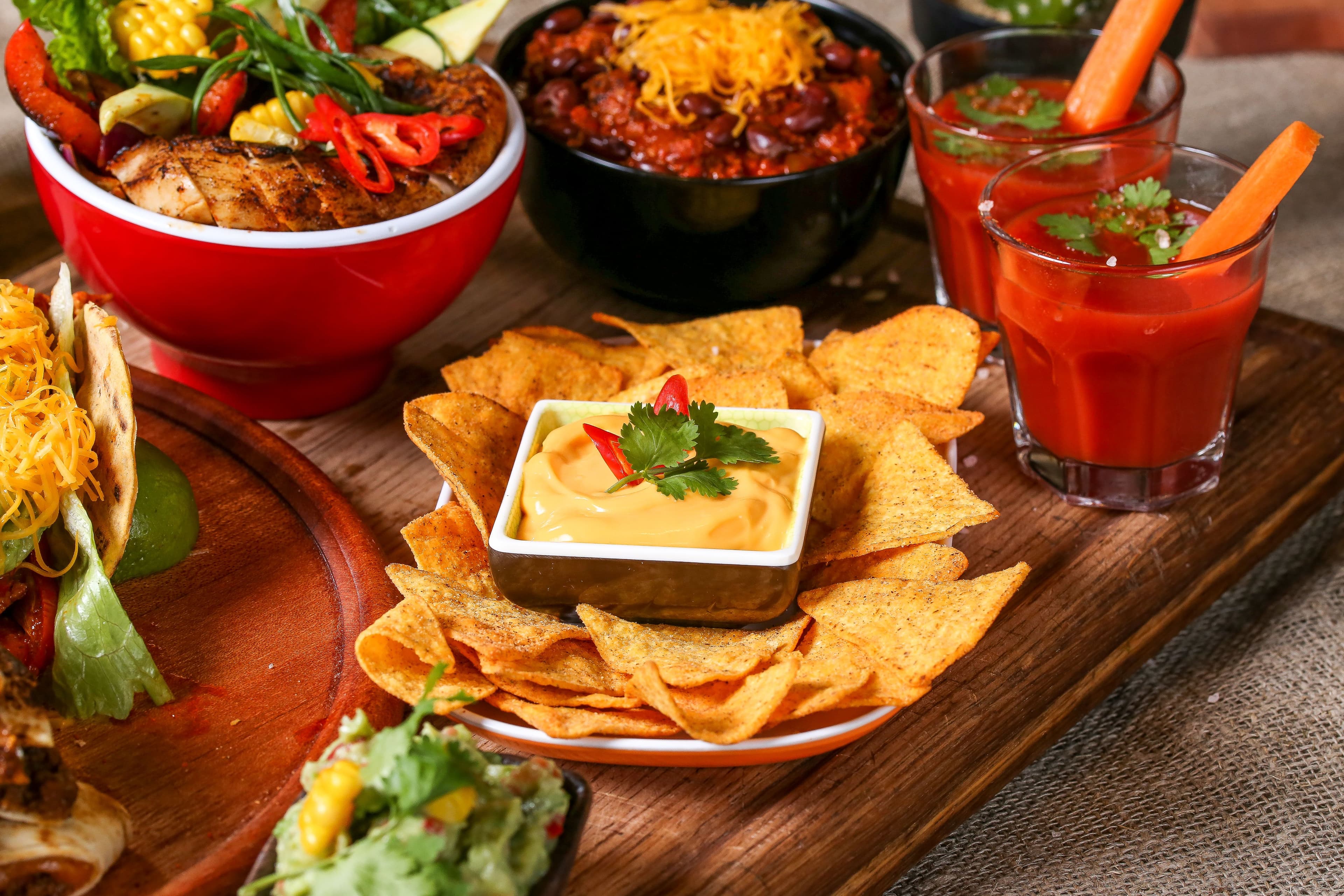 Nacho bar setup for a Mexican Cuisine appetizers party.