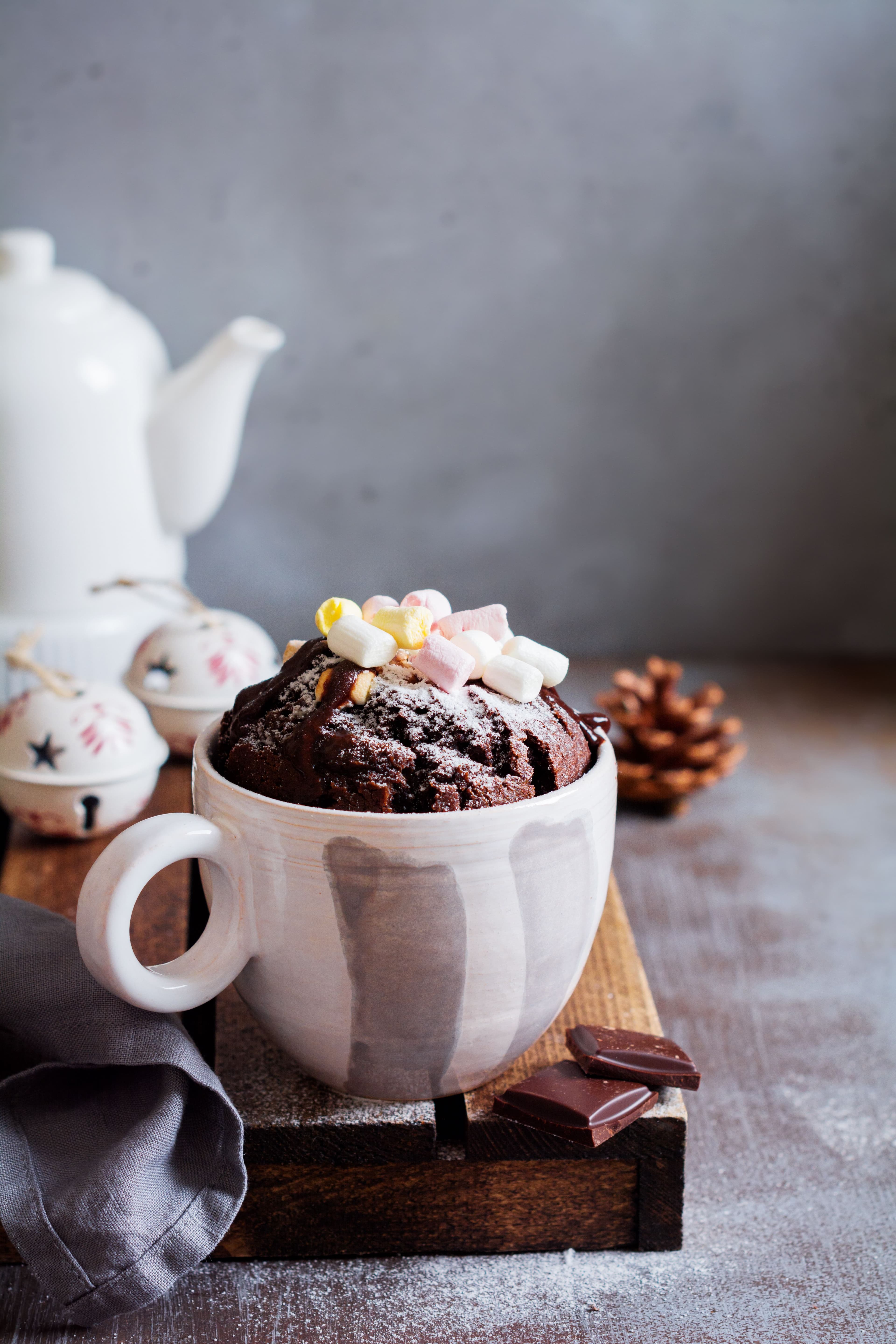 Easy to cook cup brownie in a white cup with some marshmallow toppings