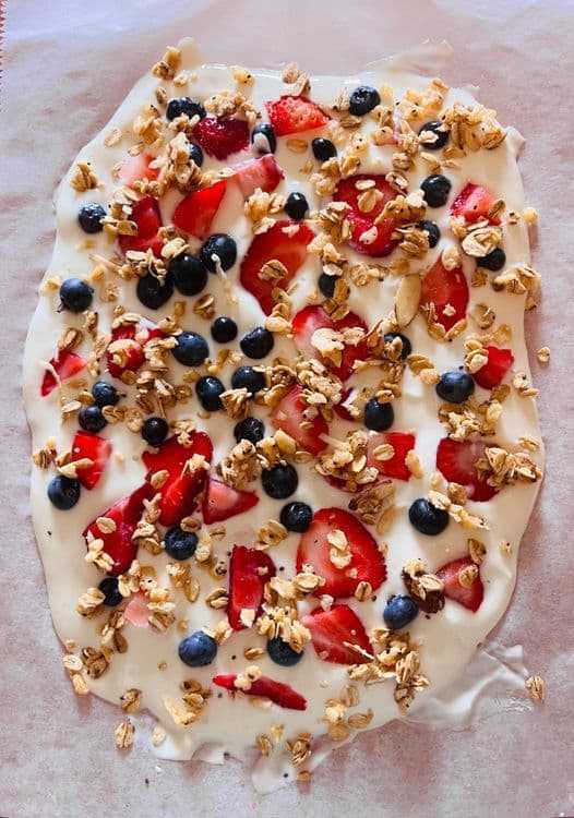 Frozen yogurt bark topped with strawberries, blueberries, and granola