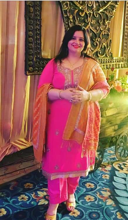 Preeti Kalia standing confidently, happy about representing her passion for authentic Punjabi cuisine.