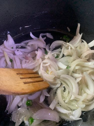 Sliced onions in a wok. 