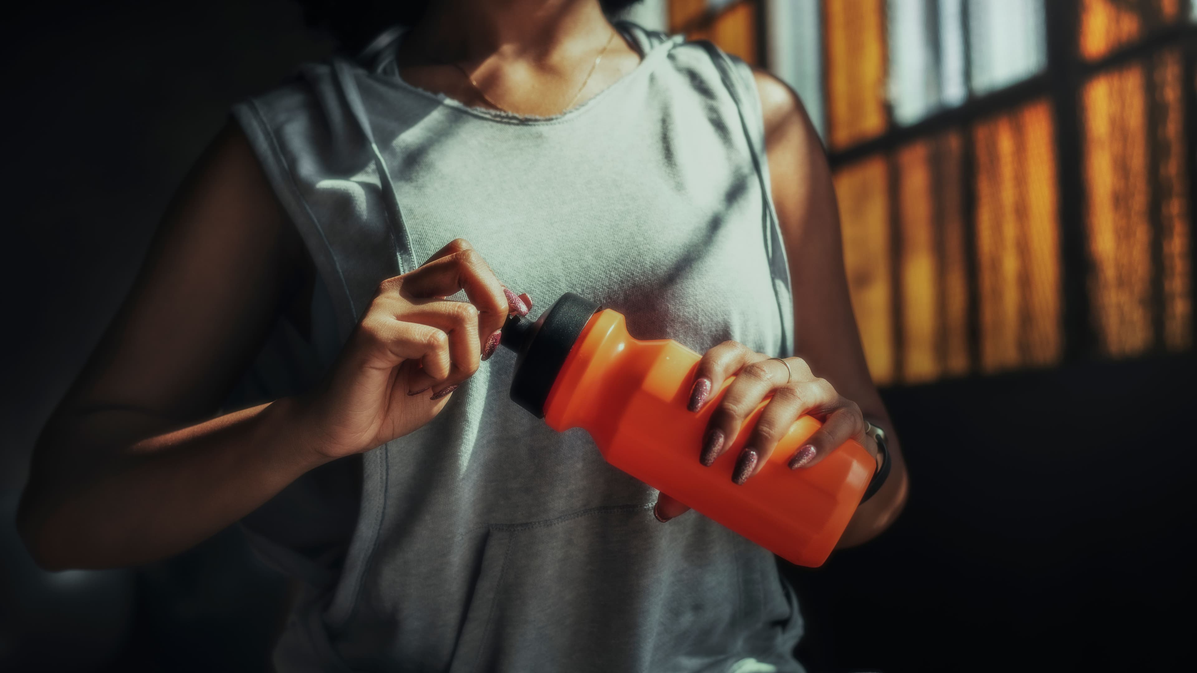 Woman hydrating after workout with smoothie recipes protein in her routine