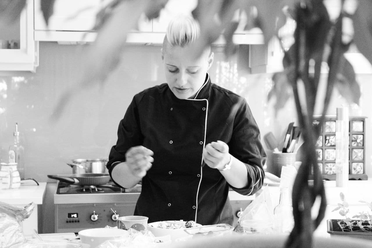 chef Anna preparing delicious meal in kitchen .