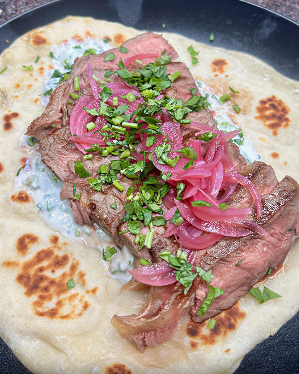 Steak with Homemade Flatbread, Garlic & Coriander Yoghurt and Pickled Red Onions recipe