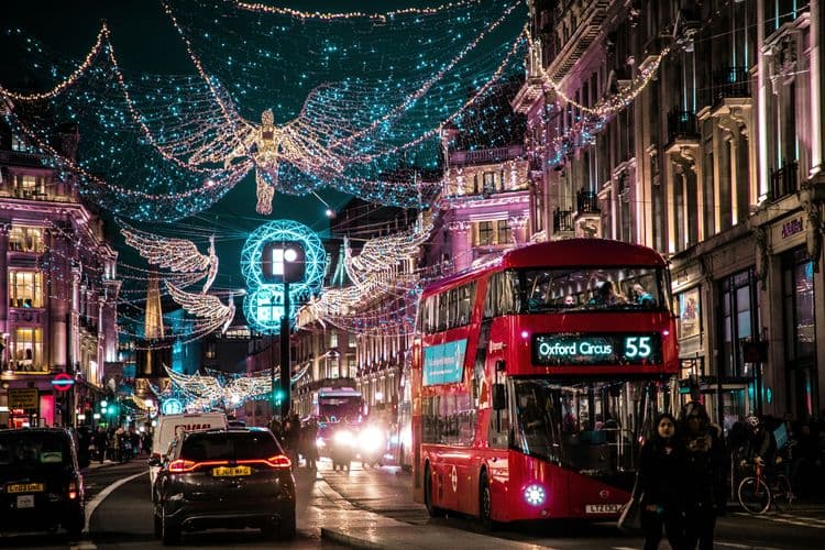 A bustling street lit up with festive lights.