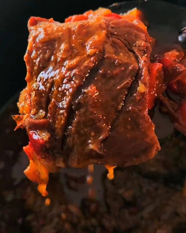 Slow-Cooked Goat Leg on a Bed of Tomatoes and Sweet Peppers recipe