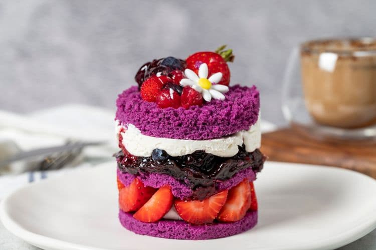 Layered fruit cake with strawberries and raspberry sauce, illustrating creative recipe writing with Chefadora